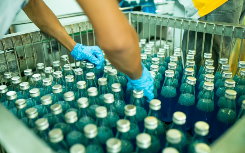 Worker packaging bottles