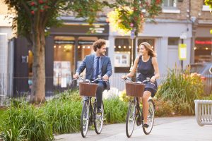 two people riding bicycles